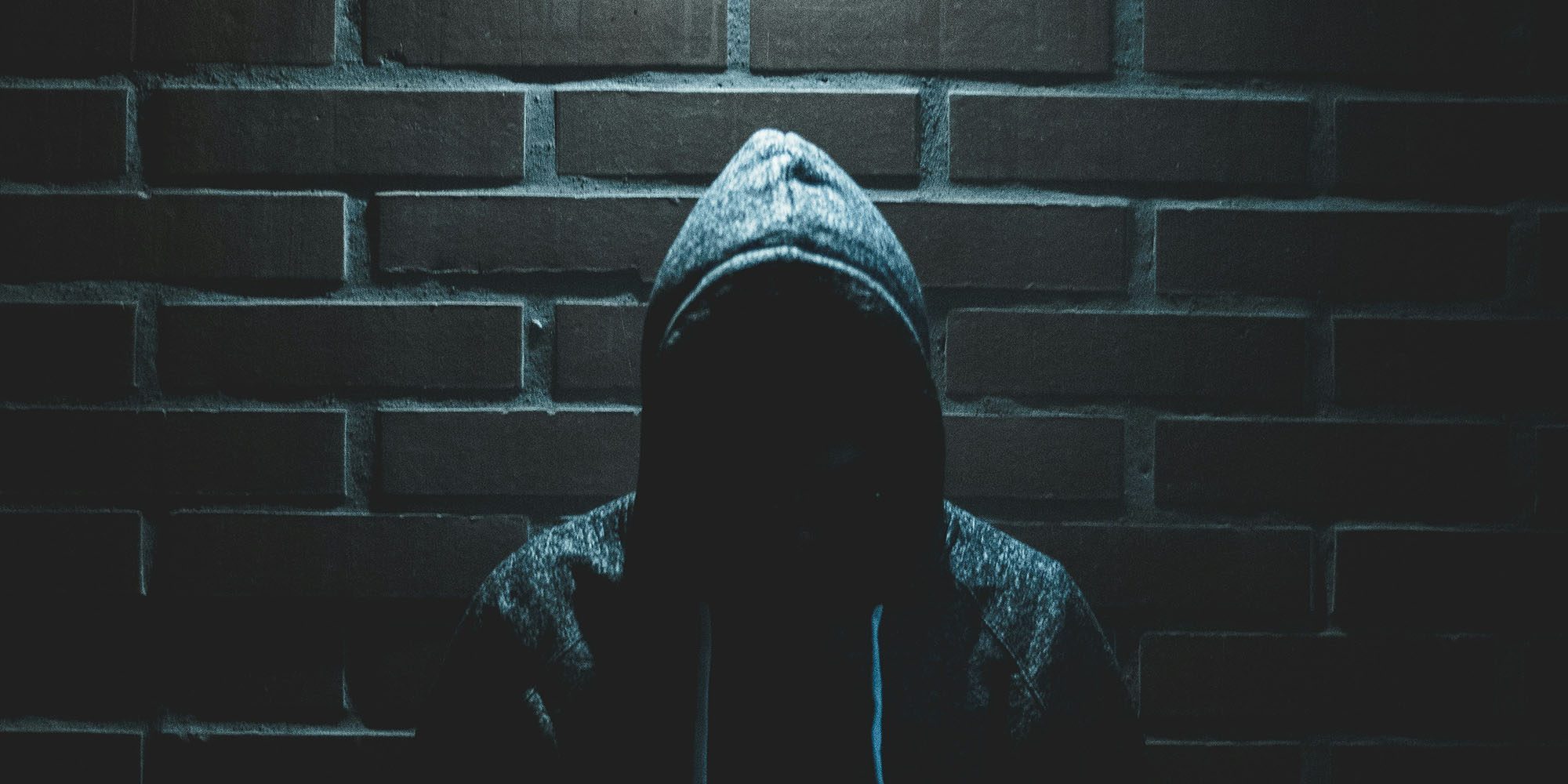 What to do if your iPhone is stolen – more detailed advice from Apple | Photo shows a face hidden by a hoodie on a dark night